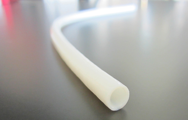 A closeup of a narrow white tube.
