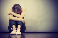 Graphic of female sitting down and curled up, associated with June 2019 research spotlight article on Youth suicide rates in the U.S. increasing, especially in younger girls.