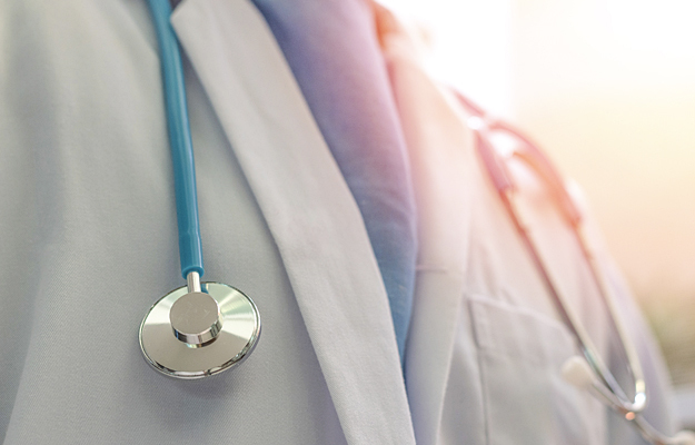 A closeup of a stethoscope around a doctor's neck.