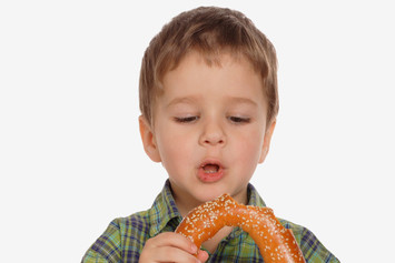 Boy with large sesame seed bagel