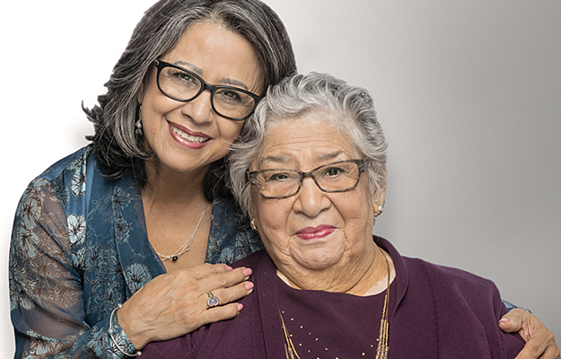 A mature woman posing with her elderly relative.