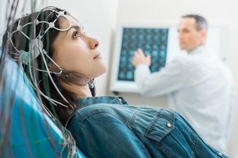 Young woman undergoing electroencephalography