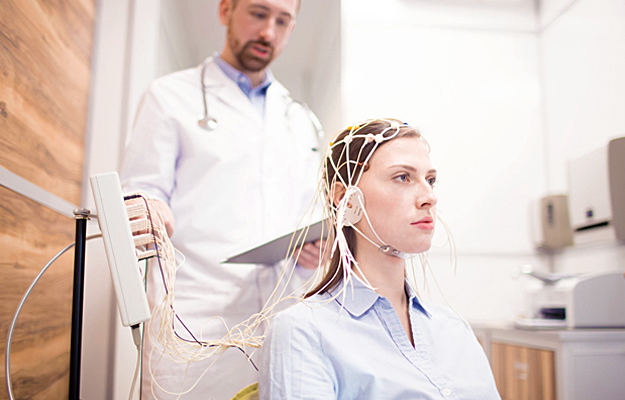 A young woman undergoing electroencephalography.