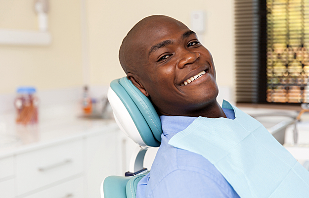 A man sitting in a dental chair.