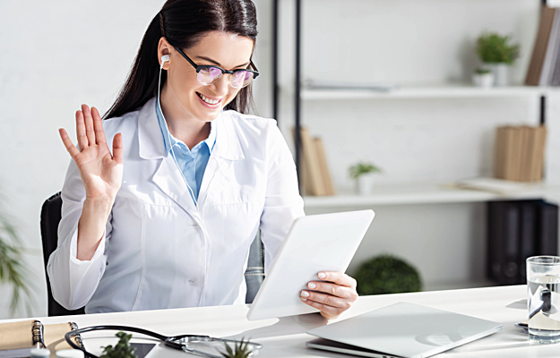 A doctor communicating on a telehealth video call.