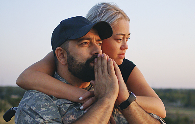 A woman supporting her veteran husband.