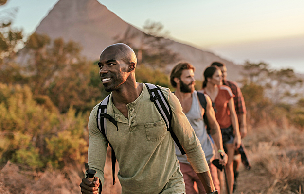 A man hiking in the mountains with friends.