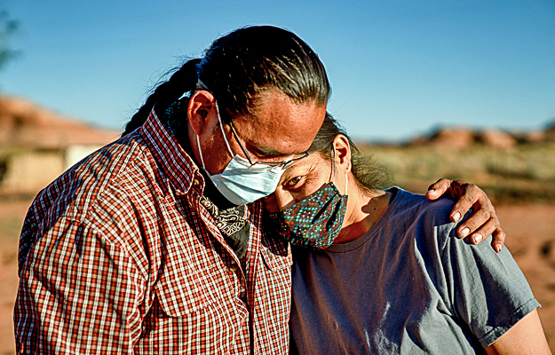 A mature couple wearing face masks.