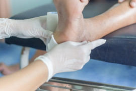 Doctor bandaging a foot wound