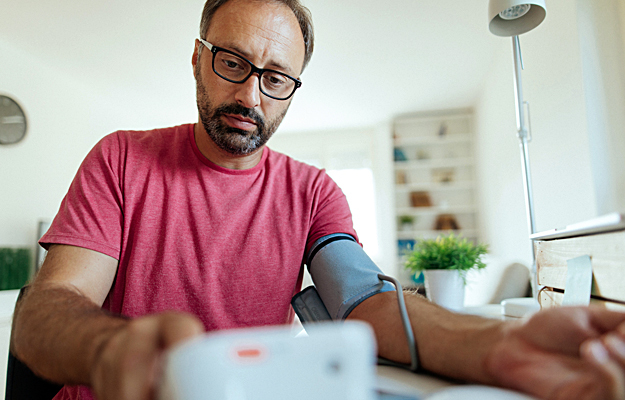 A man checking his blood pressure.