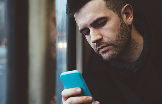 A man looking at his cell phone.