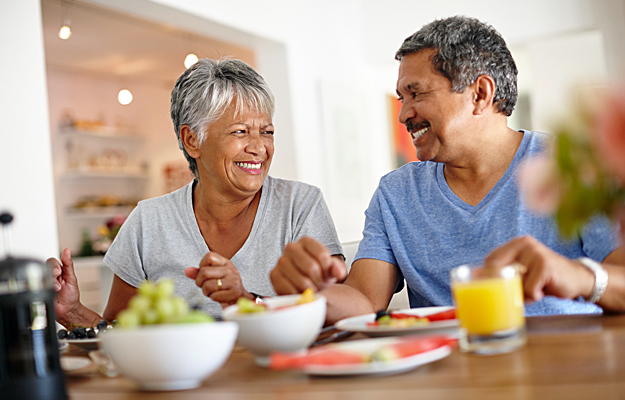 A senior couple eating breakfast together.