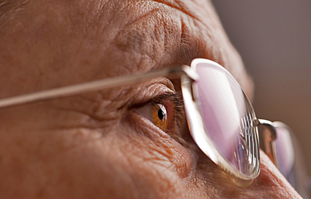 A closeup of a senior woman's eye and glasses.