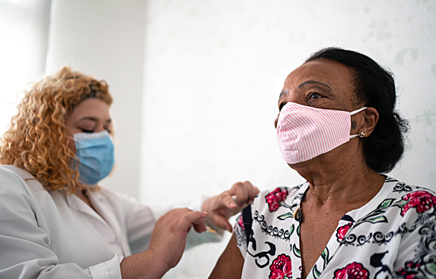 A senior woman getting a vaccine.