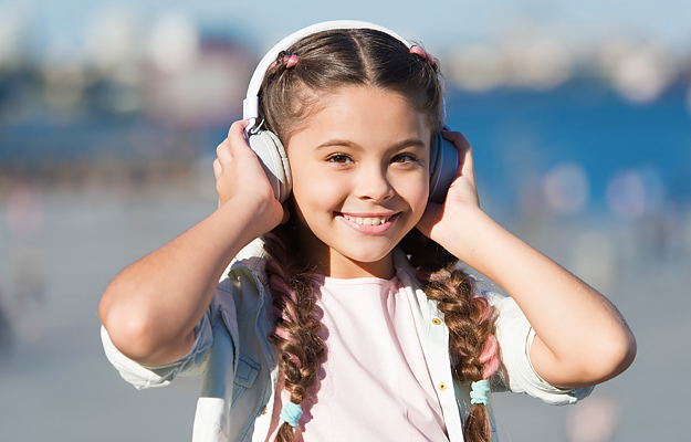 A young girl wearing protective earmuffs.