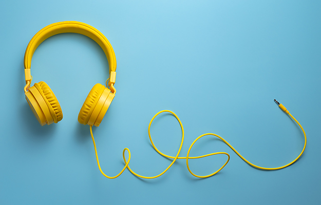 Yellow headphones on a blue background.