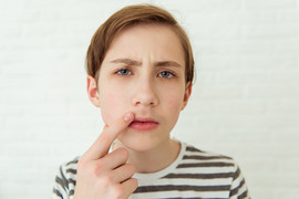 Teenage boy looking at his first mustache in a mirror