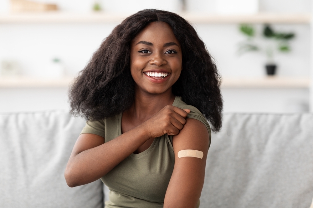 Young black woman with bandage from vaccination