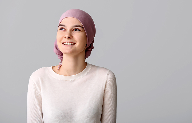 A female cancer patient wearing a headscarf.