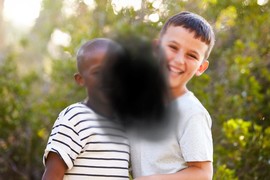 Two children obstructed by black splotch in center