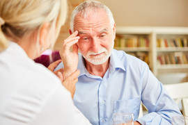 Senior man comforted by female doctor