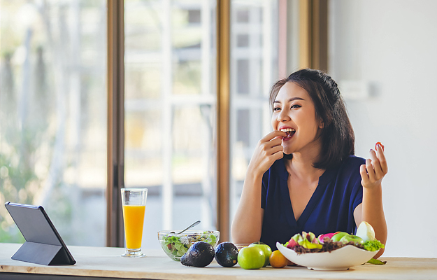 A woman eating healthy foods.