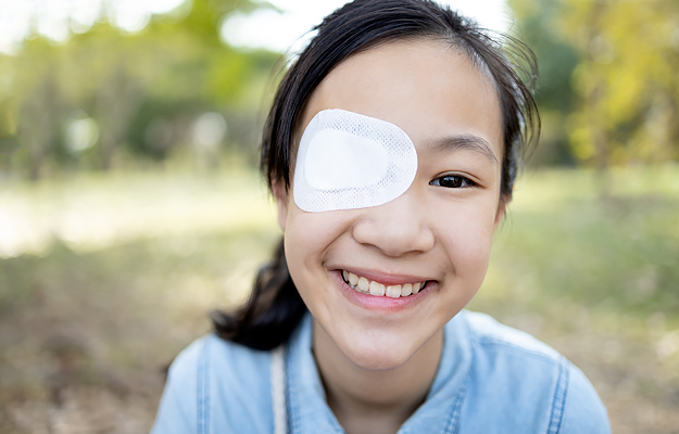 A young girl wearing an eye patch.