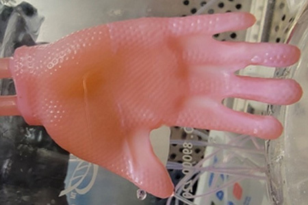 Glove made of bioengineered skin connected to ports for culture infusion in the laboratory