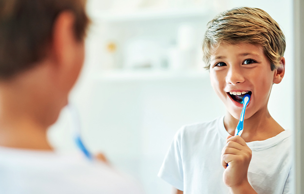 A young boy brushing his teeth.