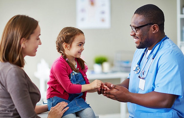 A young girl talking to a doctor.