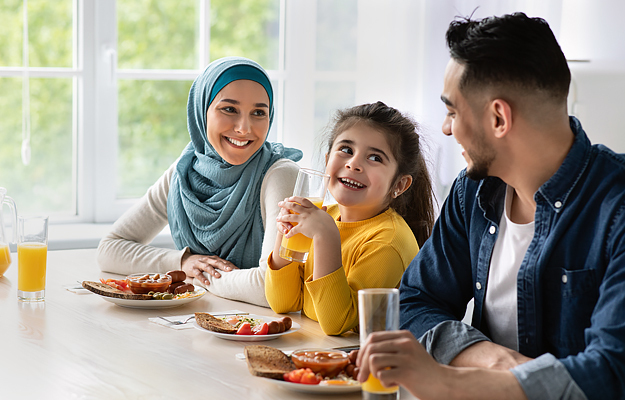A family of three eating a healthy meal.