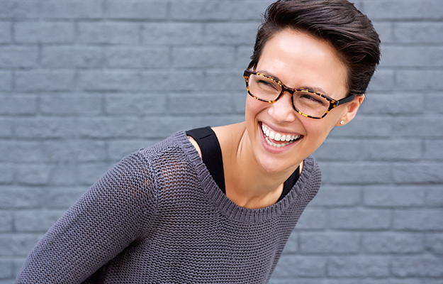 A smiling woman wearing glasses.
