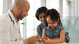 A mother and child with doctor. 