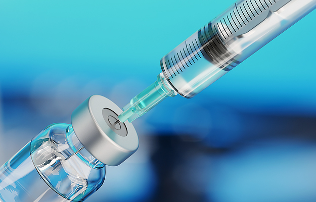 A medical syringe inside of a vial.
