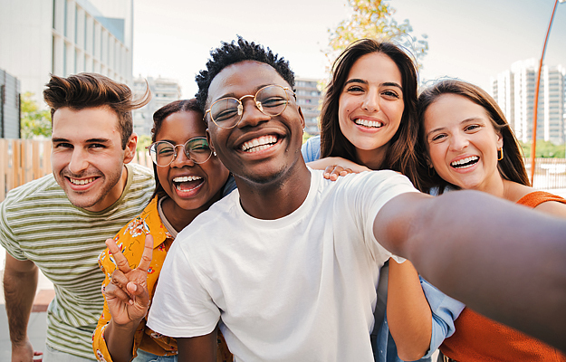 A group of teenagers taking a photo together.