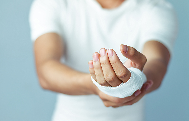 A close-up of a man's bandaged hand.