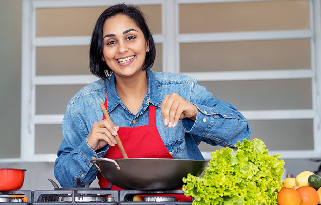 A woman cooking a healthy meal.