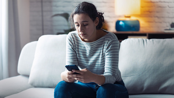 Young woman w migraine and phone