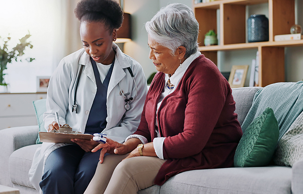 A doctor reviewing information with a senior patient.