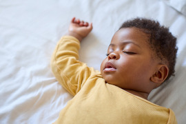 Infant girl lying on back.