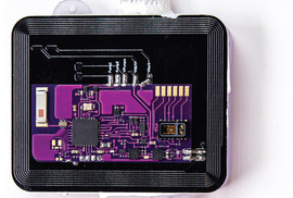 Photos of Naloximeter circuits, a side view of the device, and a top view of the device held between a finger and thumb.