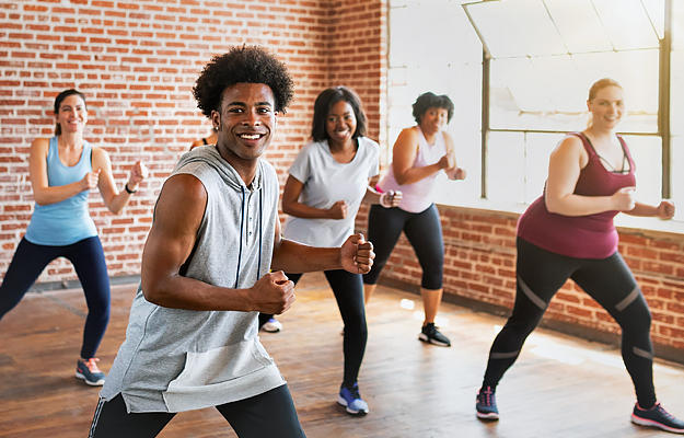 A group of people participating in an indoor workout class.