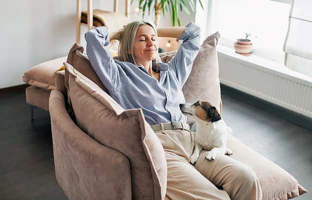 A woman relaxing at home with her dog.