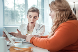 Teen with obesity speaking with a medical professional.