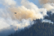 A helicopter drops water on the Cedar Creek fire outside Mazama in Washington state's Methow Valley.