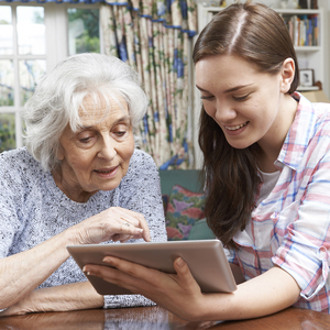 Older woman and younger woman looking at tablet