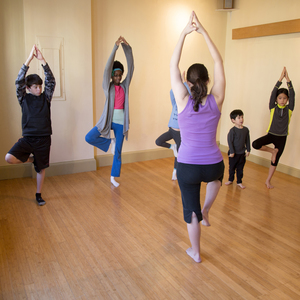 Kids doing yoga with instructor