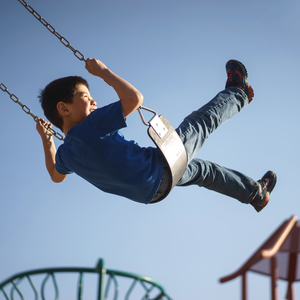 Child on a swing smiling