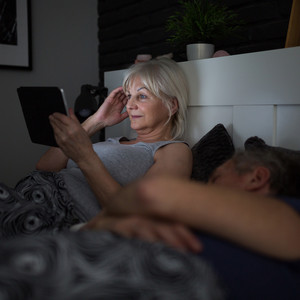 Sleep disorder woman on tablet