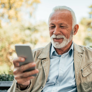 Senior man researching information on his phone